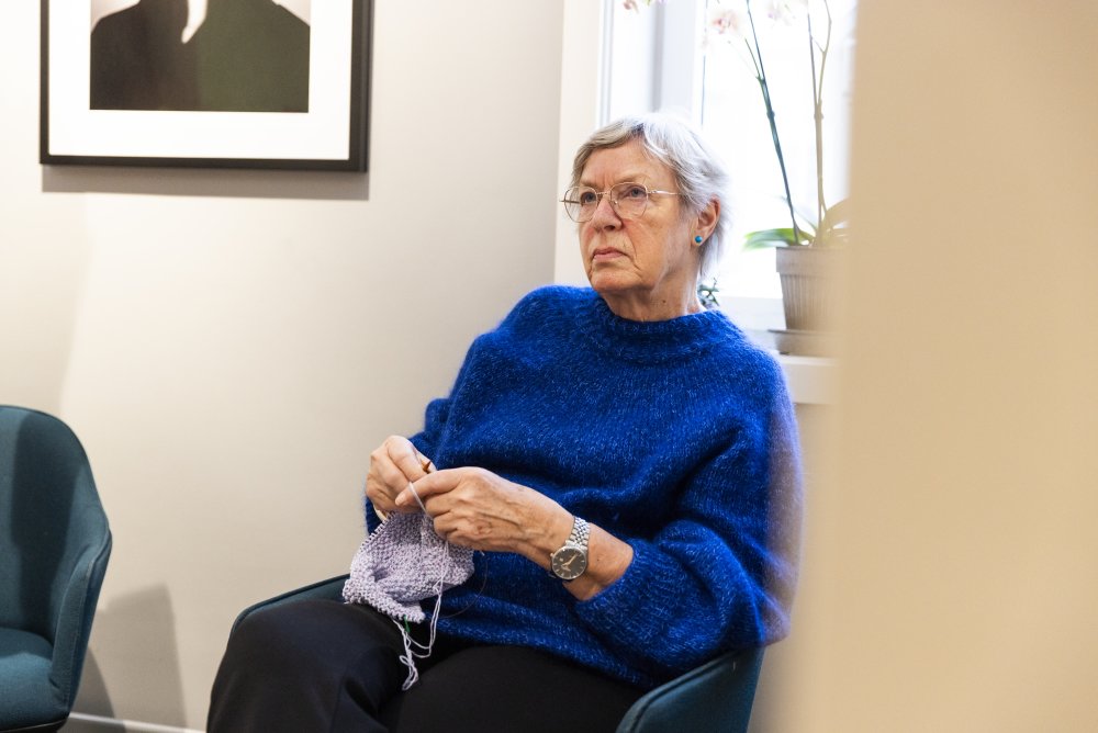 Kunde hos Interoptik sitter på venterommet og strikker